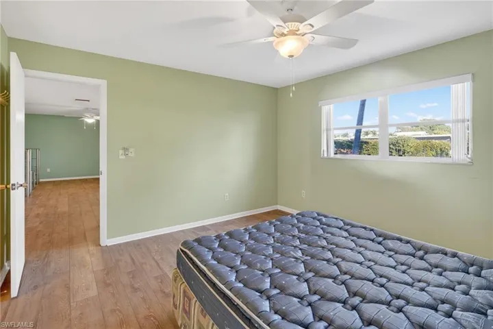 Bedroom featuring wood finished floors and a ceiling fan