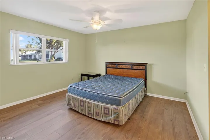 Bedroom featuring wood-type flooring and a ceiling fan