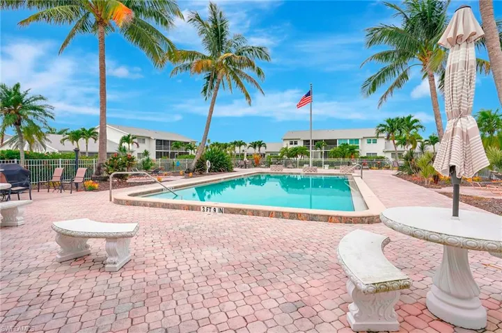 Community pool featuring a patio and a residential view