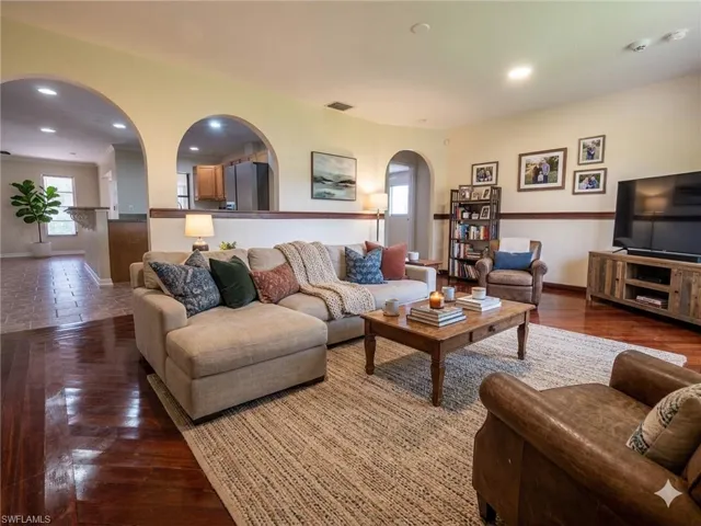 Living area featuring wood-finish flooring, recessed lighting, and a neutral color palette