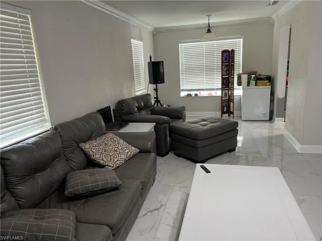 Living room featuring crown molding