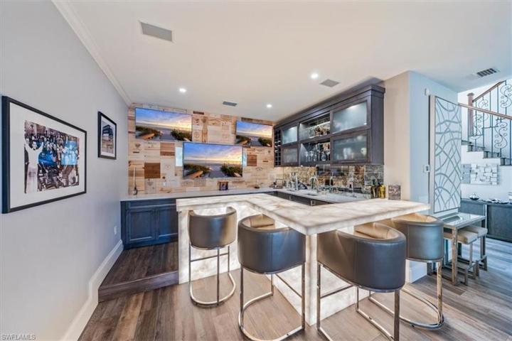 Custom Bar with integrated lighting, beverage refrigerator, ice maker and kegerator