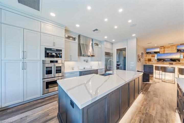 Chef's kitchen with Sub Zero Refrigerator, GE Monogram double wall ovens, dishwasher & induction range, Miele coffee maker and drawer microwave