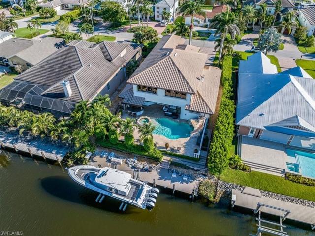 Aerial view of home highlighting boat dock and resort entertainment areas