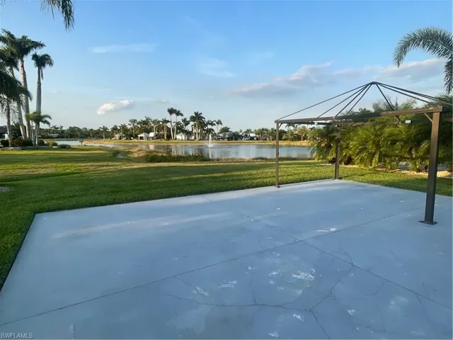 Surrounding community with a water view, a patio, and a gazebo