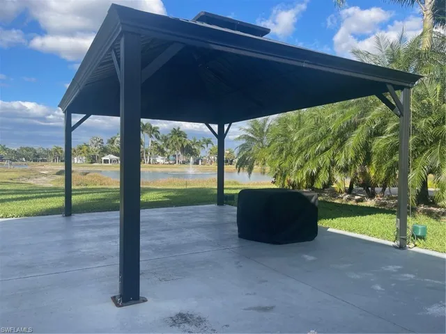 View of patio with a gazebo, a water view, and a grill