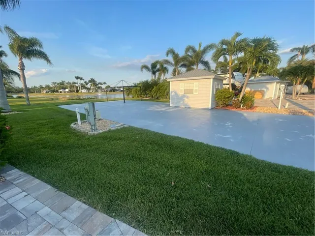 View of green lawn featuring driveway