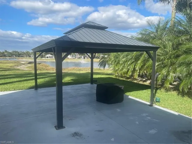 View of home's community with a gazebo, a water view, and a patio