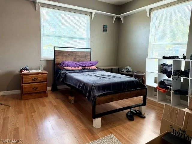 The first of the two guest bedrooms with laminate flooring and two large windows