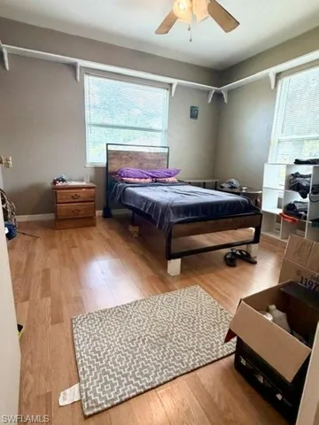 The first of the two guest bedrooms with laminate flooring and two large windows