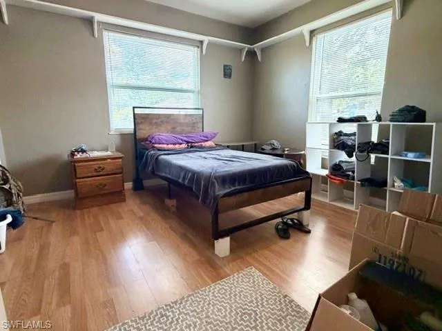 The first of the two guest bedrooms with laminate flooring and two large windows