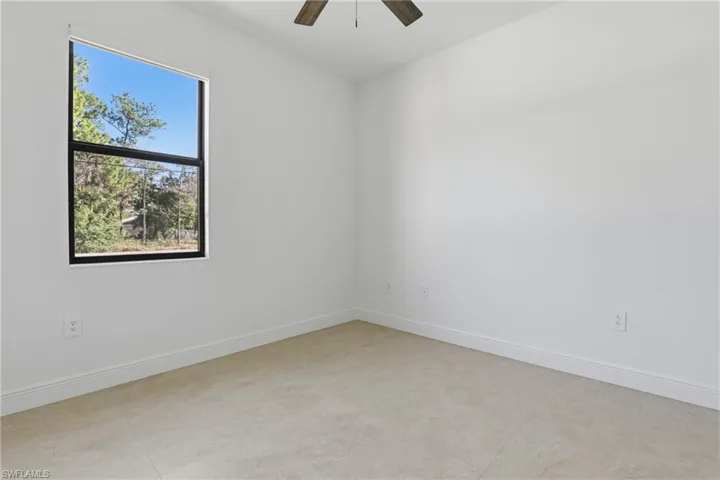 Spare room with baseboards and ceiling fan