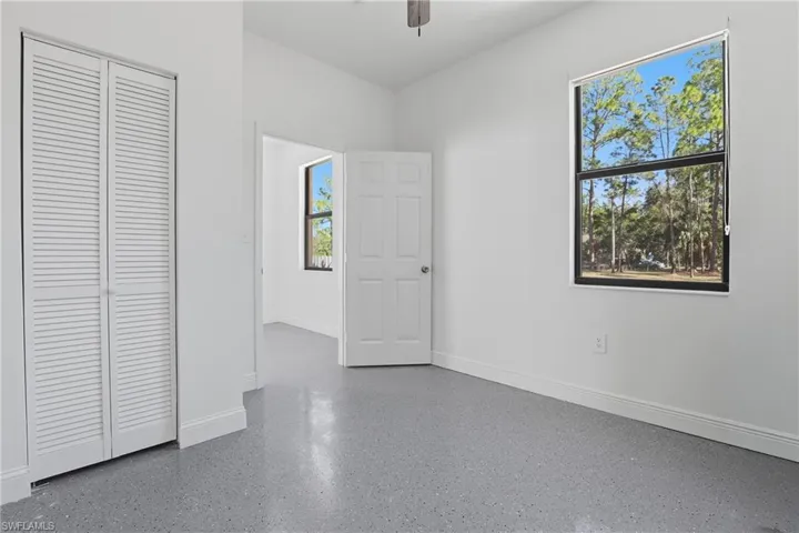 Unfurnished bedroom with a closet and ceiling fan
