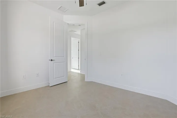 Empty room with concrete floors and ceiling fan