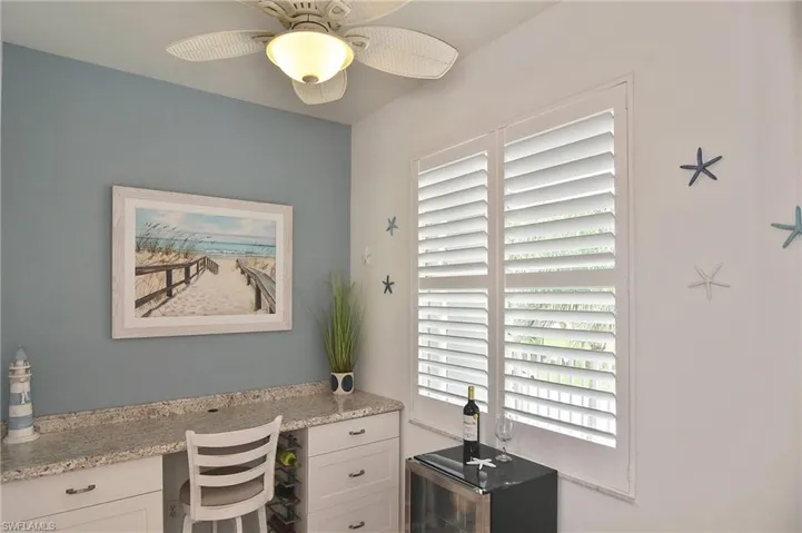 Home office with built in study area and ceiling fan