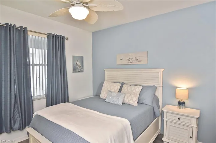 Bedroom with ceiling fan and baseboards