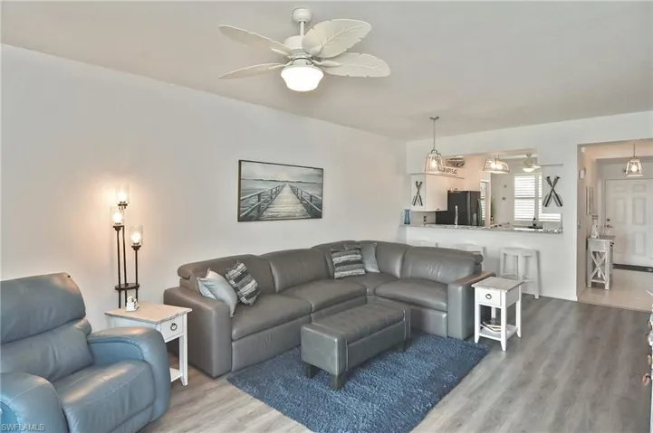 Living room featuring light wood-style floors and a ceiling fan