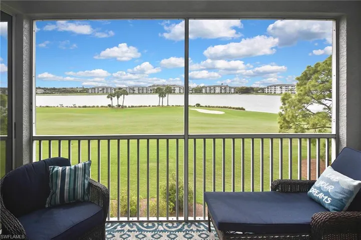 Sunroom / solarium featuring golf course view and a water view