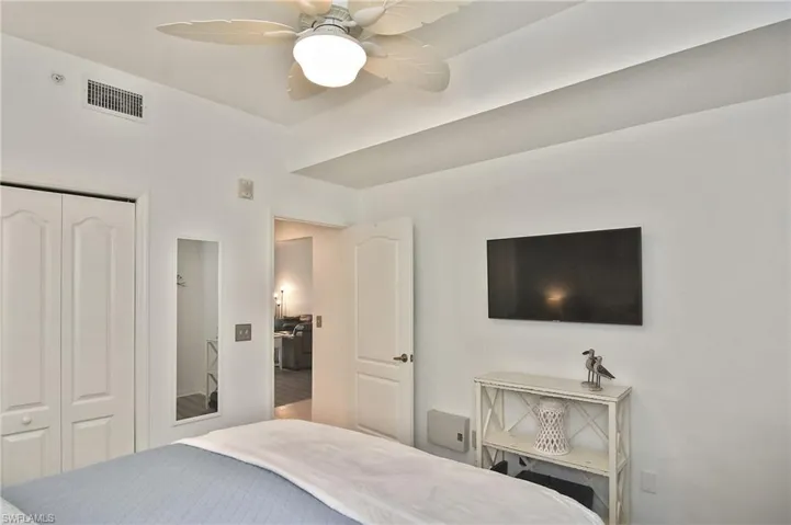 Bedroom with a ceiling fan and a closet