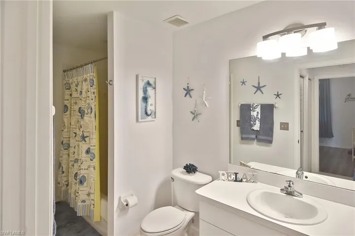 Full bathroom featuring vanity and shower / bath combination with curtain