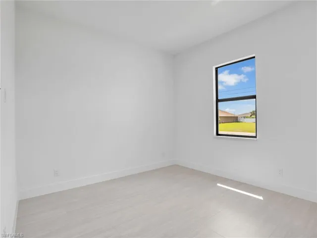 Empty room featuring baseboards