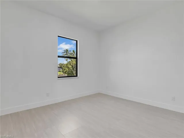 Unfurnished room with baseboards