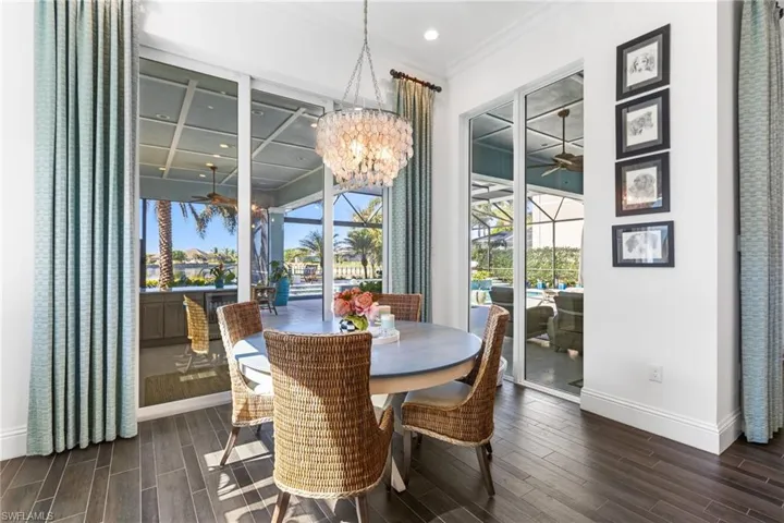 Dining space featuring a notable chandelier, dark hardwood / wood-style flooring, crown molding, and coffered ceiling