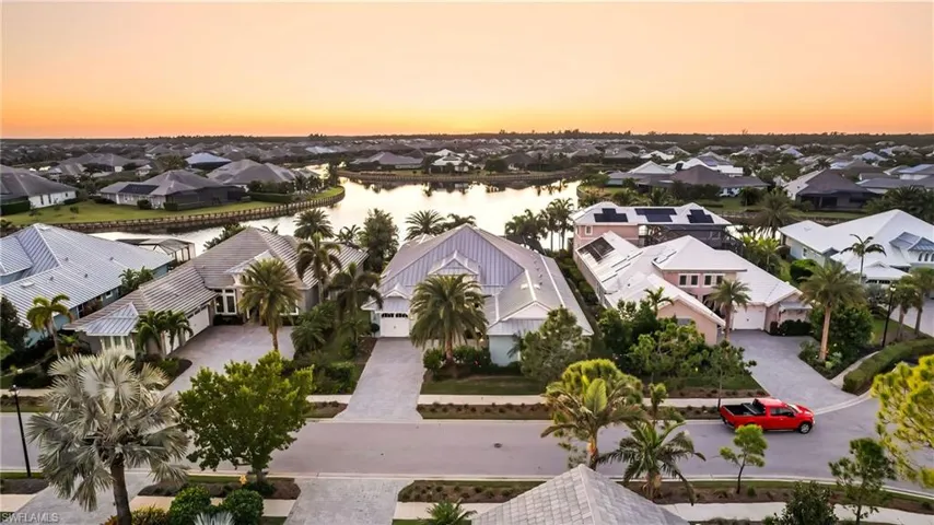 Aerial view at dusk featuring a water view