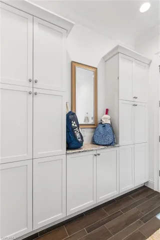 Mudroom featuring dark hardwood / wood-style flooring and ornamental molding