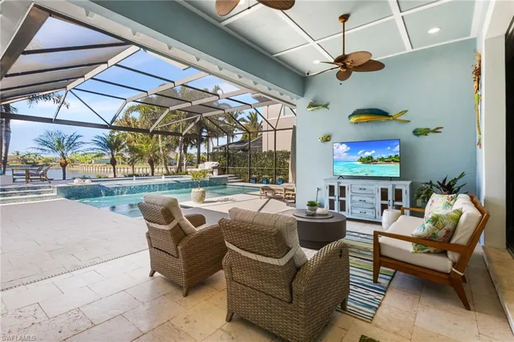 View of patio featuring french doors, an outdoor hangout area, pool water feature, ceiling fan, and glass enclosure