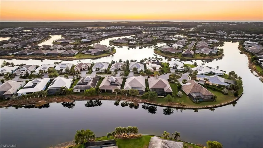 Aerial view at dusk featuring a water view