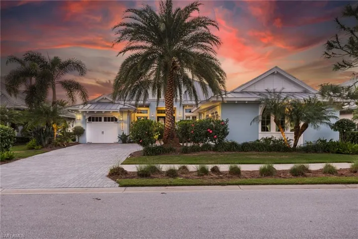 View of front of home featuring a yard and a garage