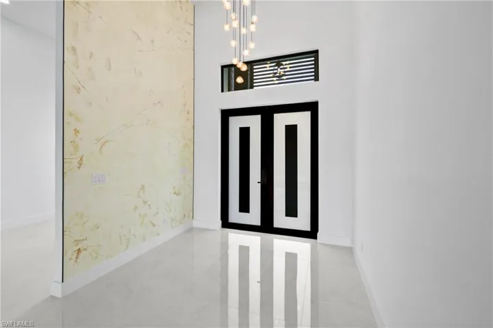 Detailed view of a chandelier and baseboards