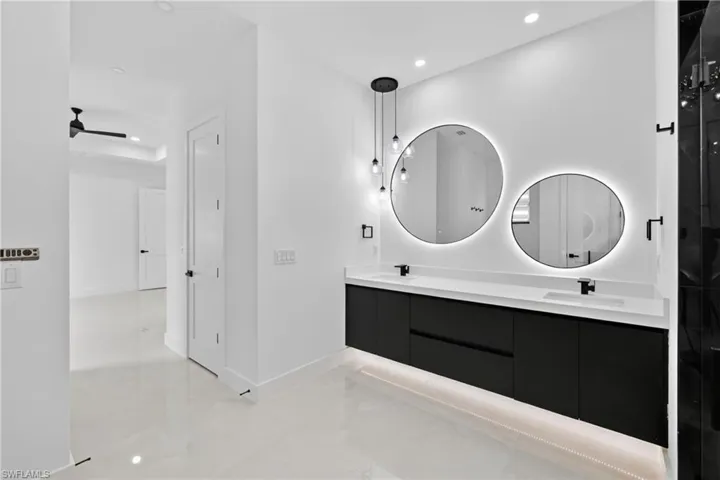 Bathroom with recessed lighting and double vanity