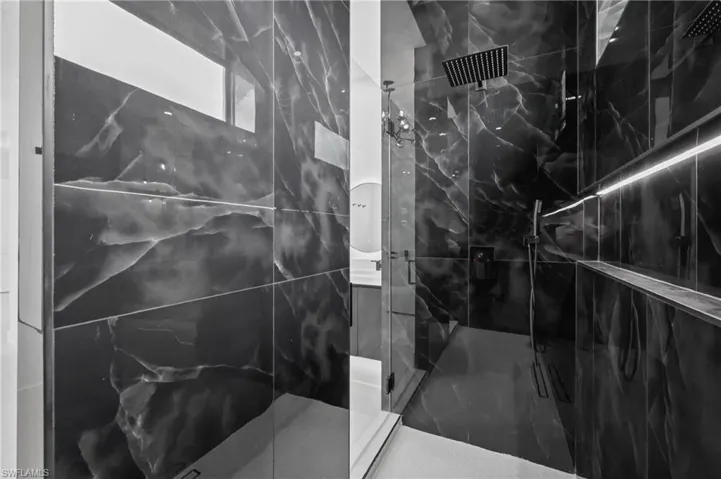 Bathroom with a marble finish shower