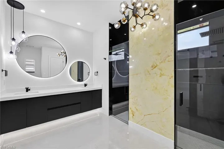 Full bath with a chandelier, a shower stall, double vanity, wine cooler, and recessed lighting