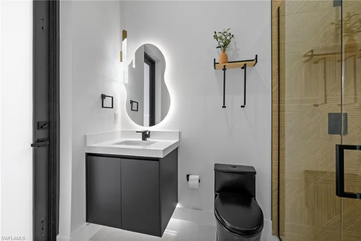 Full bath with vanity and a shower stall