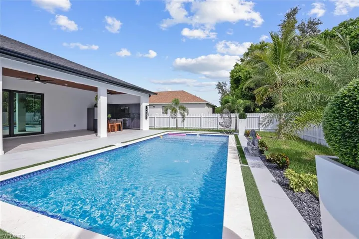 View of pool with a fenced backyard, a ceiling fan, and a patio area