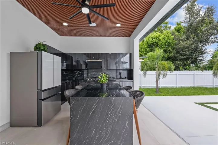 View of patio with a ceiling fan and a sink