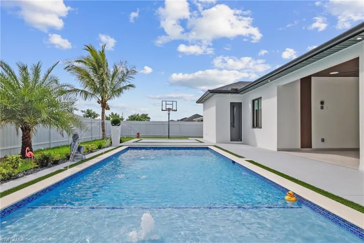 View of swimming pool with a fenced backyard and a patio