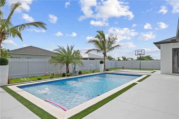 View of swimming pool with a fenced backyard and a patio