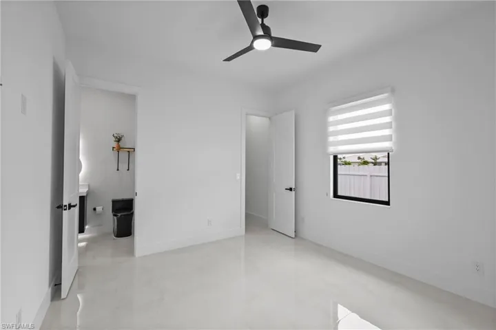 Unfurnished bedroom featuring a ceiling fan and light tile patterned floors