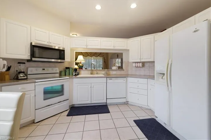 Tiled bedroom with a closet, carpet floors, and ceiling fan