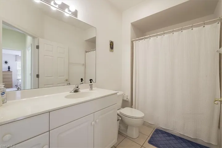 View of property with uncovered parking