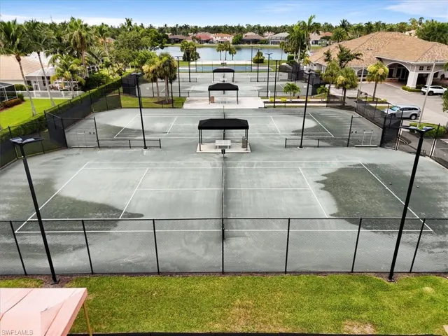 Living area featuring light tile patterned floors, ceiling fan, and arched walkways