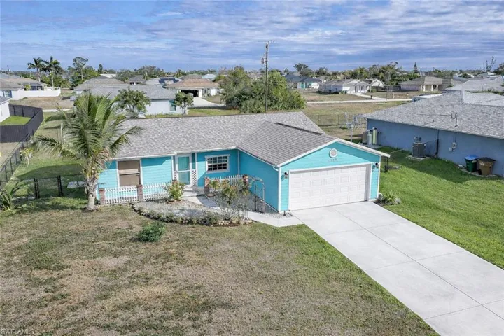 Ranch-style home featuring a residential view, driveway, and an attached garage