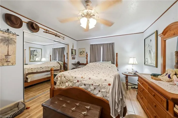 Bedroom featuring a closet, light wood-style floors, and ceiling fan