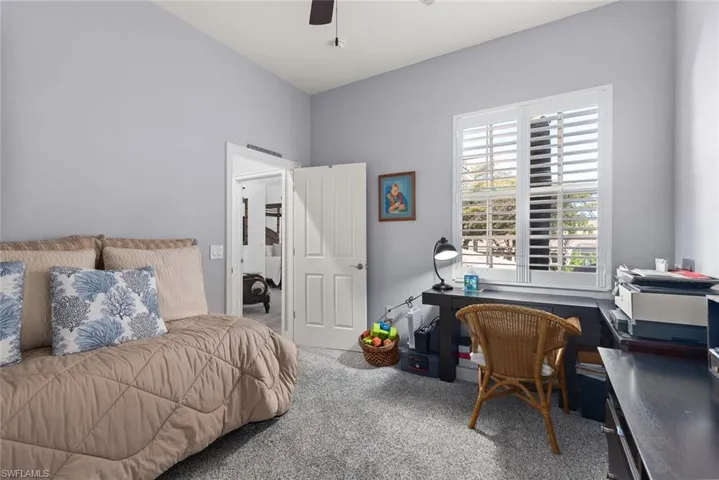 Bedroom featuring carpet flooring, a desk, and ceiling fan