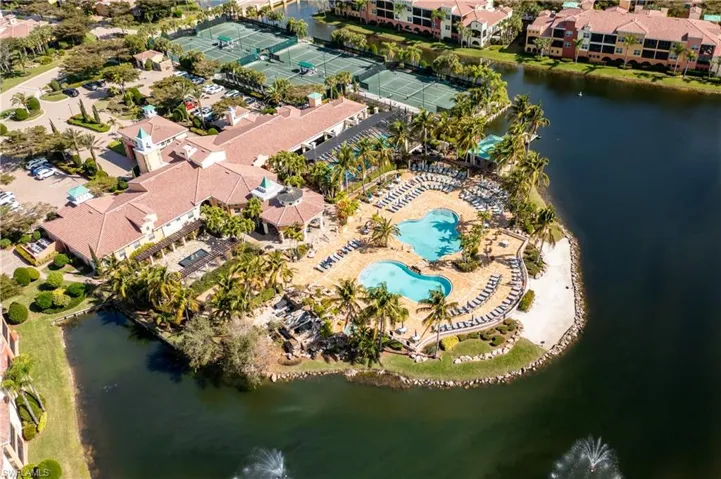 Drone / aerial view of a nearby body of water and a pool