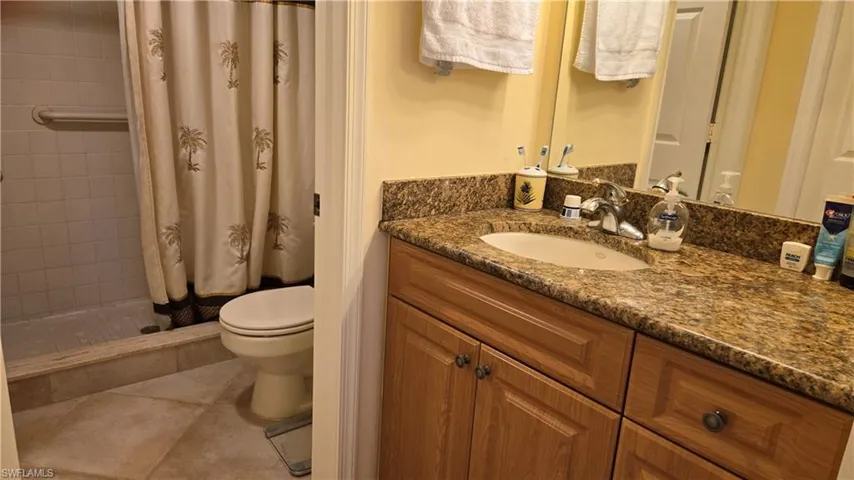 Upgraded vanity with granite counter and walk-in shower